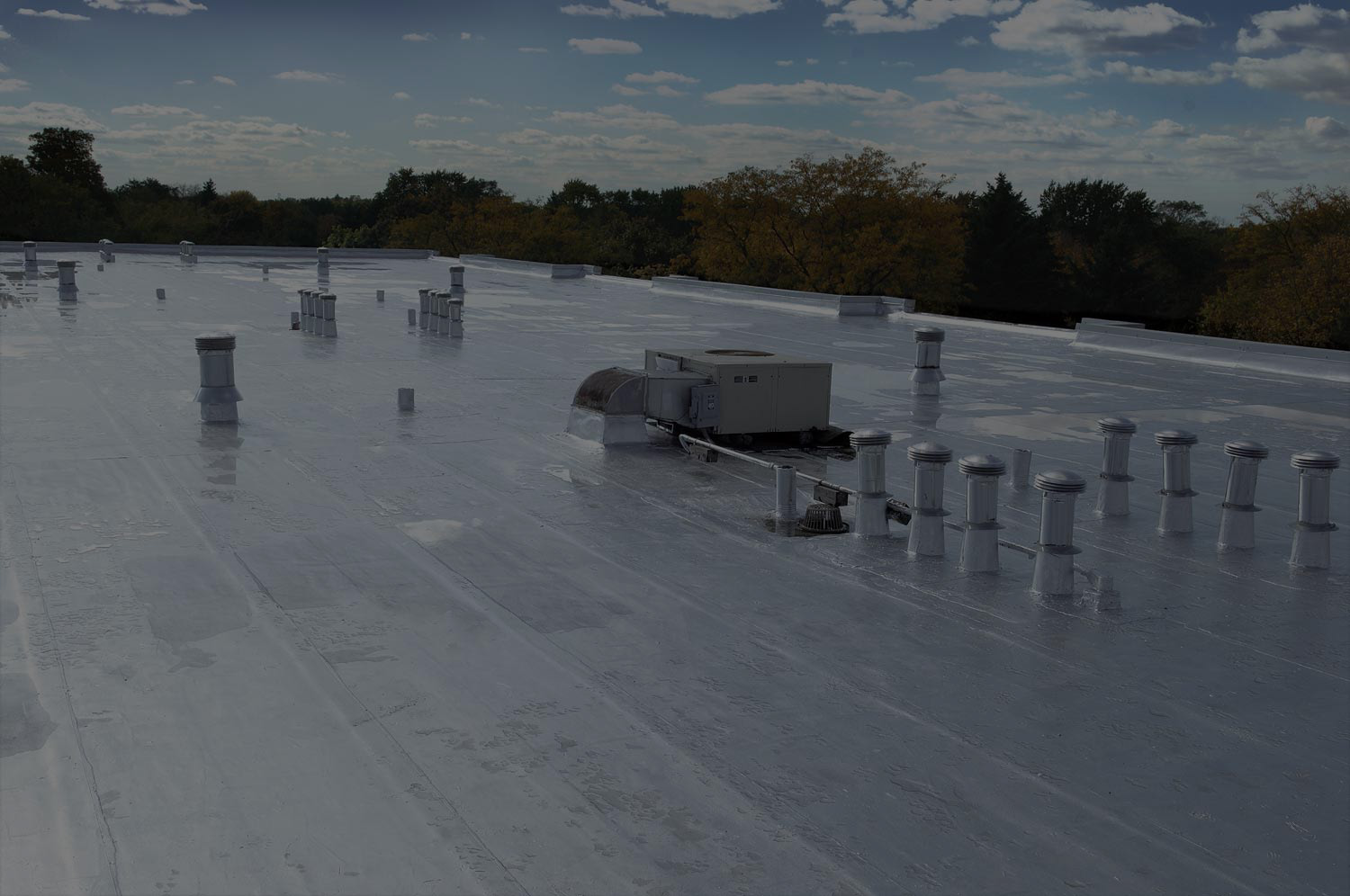 Restored low-slope commercial roof with rooftop equipment